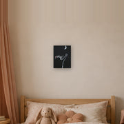 At least I tried canvas print by Artis Berkmanis, a white kitten reaching for a crescent moon on a black background. Shown at 23 x 30 cm in a Scandinavian children's room.