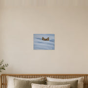 I am not lost, only hiding art poster by Artis Berkmanis, two fox ears rising above soft blue-white snow. Unframed matte print shown at 40 x 30 cm above a bed in a calm Scandinavian bedroom.