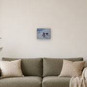 No one said it's not allowed canvas print by Artis Berkmanis, purple crocuses pushing up through white snow. Shown at 25 x 20 cm above a sofa in a Scandinavian living room.
