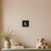 I am not as small as I look canvas print by Artis Berkmanis, a small white kitten stepping out of a black background. Shown at 20 x 20 cm in a Scandinavian children's room.