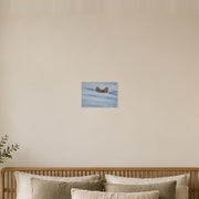 I am not lost, only hiding art poster by Artis Berkmanis, two fox ears rising above soft blue-white snow. Unframed matte print shown at 30 x 21 cm above a bed in a calm Scandinavian bedroom.