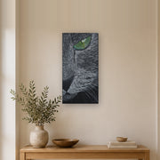 I saw you first canvas print by Artis Berkmanis, a grey cat's green eye watching from the dark. Shown at 30 x 61 cm in a Scandinavian hallway.