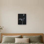 At least I tried canvas print by Artis Berkmanis, a white kitten reaching for a crescent moon on a black background. Shown at 30 x 41 cm above a bed in a calm Scandinavian bedroom.