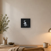 I am not as small as I look canvas print by Artis Berkmanis, a small white kitten stepping out of a black background. Shown at 20 x 20 cm above a desk in a Scandinavian home office.