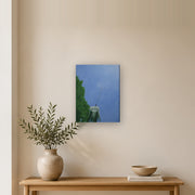 I am a beginning, not an ending canvas print by Artis Berkmanis, a single dandelion seed lifting off into a clear blue sky. Shown at 30 x 41 cm in a Scandinavian hallway.
