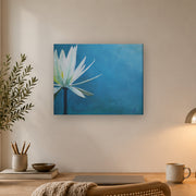 I am canvas print by Artis Berkmanis, a white water lily on a deep blue background. Shown at 51 x 41 cm above a desk in a Scandinavian home office.