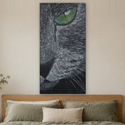 I saw you first canvas print by Artis Berkmanis, a grey cat's green eye watching from the dark. Shown at 61 x 122 cm above a bed in a calm Scandinavian bedroom.