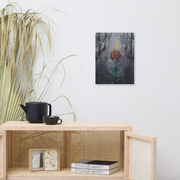 Everything was already burning, but I kept blooming canvas print by Artis Berkmanis – front view, blooming red rose with green leaves in a grey forest