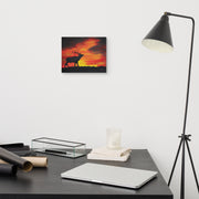 Where the sun becomes a beast canvas print by Artis Berkmanis on a light wall above a desk with a black floor lamp