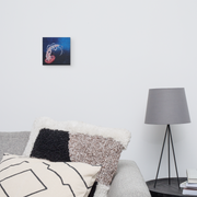 Beauty that must not be touched canvas print by Artis Berkmanis on a light grey wall above a bed with patterned pillows and a lamp