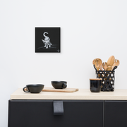 I am not as small as I look canvas print by Artis Berkmanis on a light wall above a dark sideboard with kitchen utensils