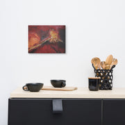 The flower that became a catastrophe canvas print by Artis Berkmanis on a light wall above a dark sideboard with kitchen utensils